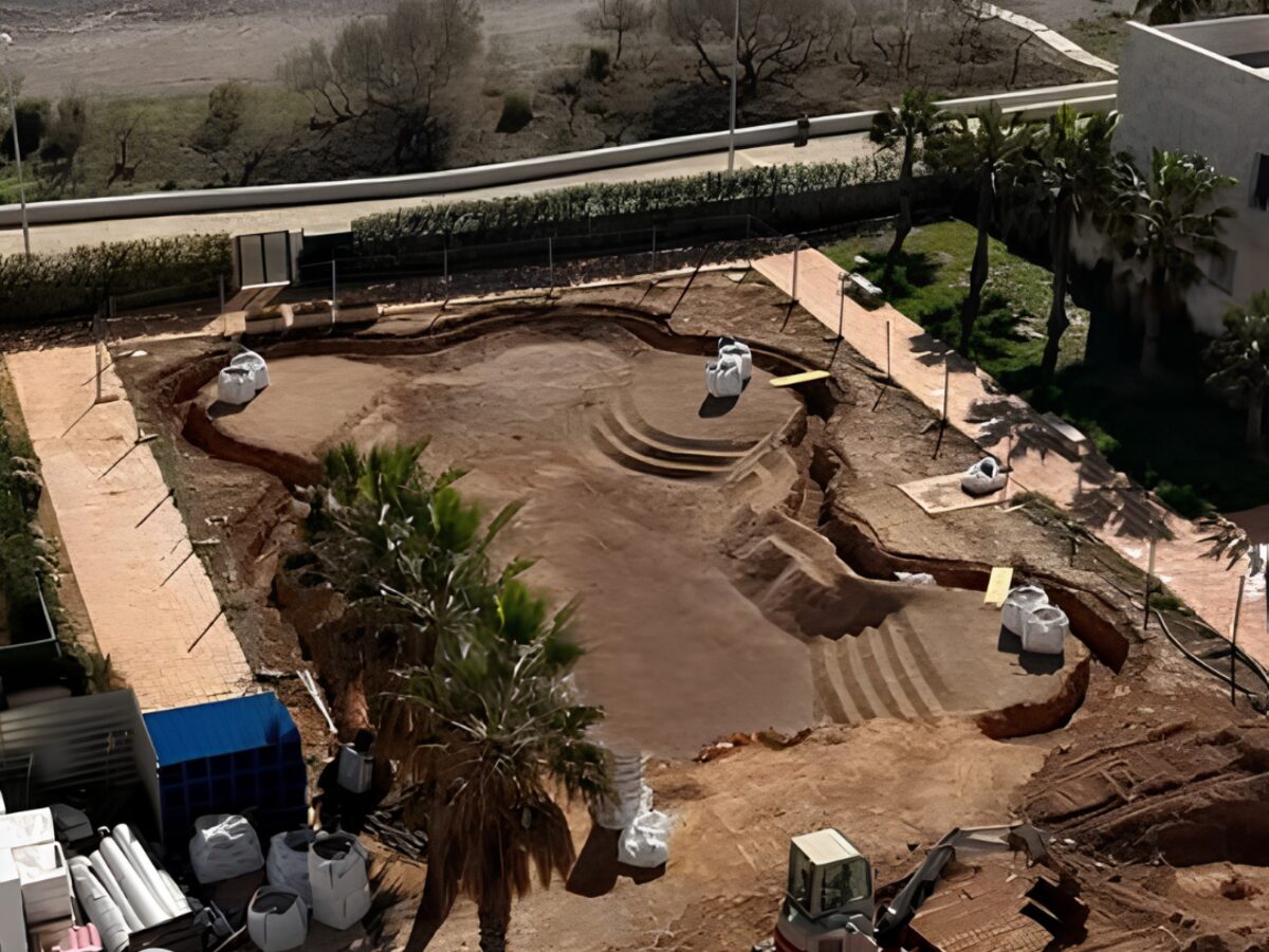 Excavated Bio.design pool site with shaped beach entry, benches and steps