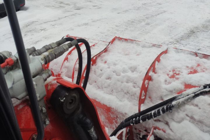 heavy machinery for ice removal, showcasing a snowy Ottawa landscape in the backdrop, indicative of diligent winter maintenance and safety services