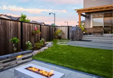 two queens home services modern backyard with a fire pit